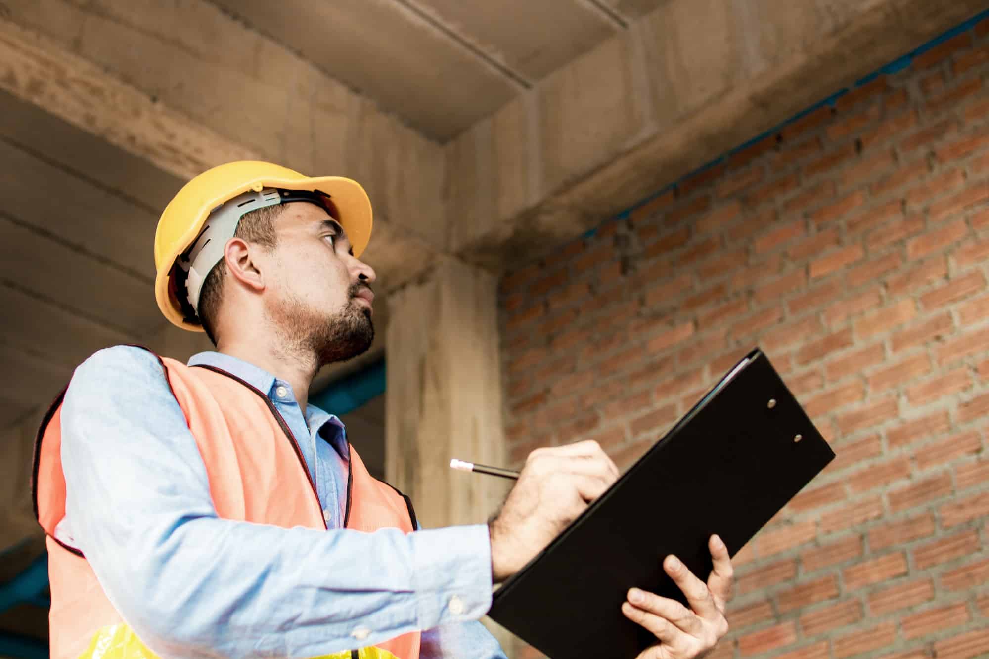 Engineer or inspector checking progressing work in construction site